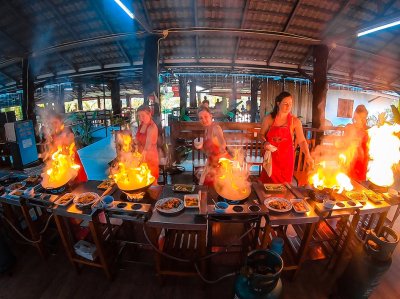 Creating flames from the wok in a cooking class in Chiang Mai Thailand