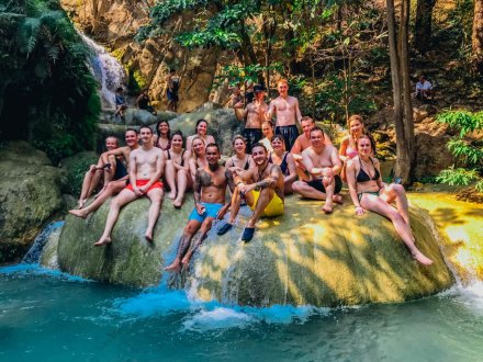 A group shot on a rock at Erawan falls in Thailand 
